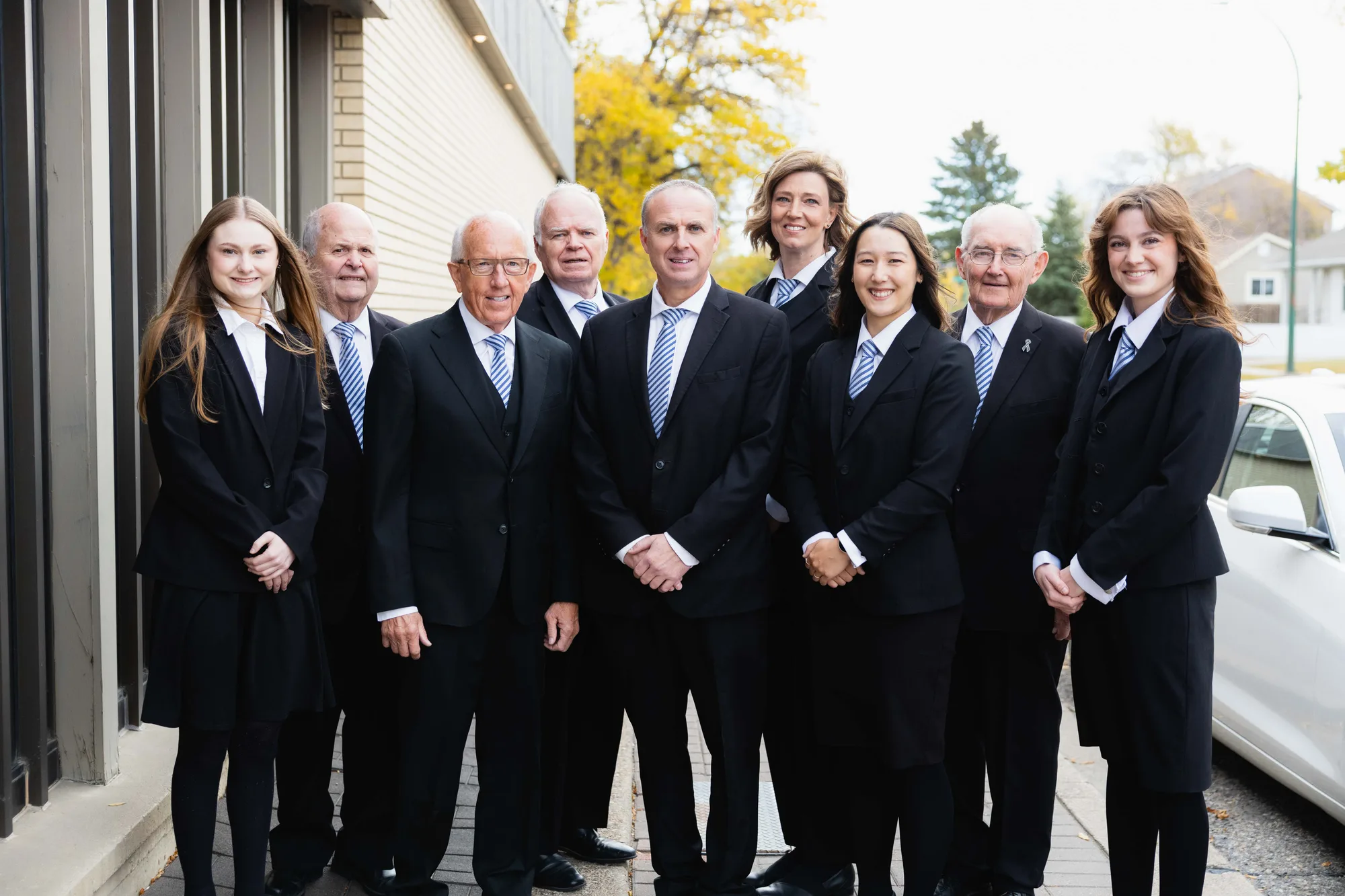 The Generations funeral directors and staff standing together outside the funeral home in Lethbridge